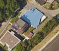 buildings with parking area, swimming pool, solar panels on the roof