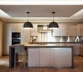 Modern kitchen with island, high ceilings, wooden floors, stainless steel countertops, built-in oven, open cabinets, pendant lights, large windows, glass doors to balcony