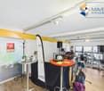 Interior setup with tables, musical instruments, drum set, and decorative items