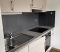 modern kitchen with stainless steel sink, gas stove, oven, under cabinet lighting, cabinets, countertops