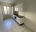 white cabinets, black countertops, tiled floor, gas stove, window, white ceiling