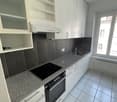 white cabinets, tiled countertop, induction stove, integrated oven, sink, tiled floor
