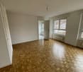 large room, parquet flooring, large windows, white walls, two doors, two empty rooms