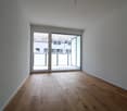 empty room, glass sliding doors leading to terrace, white walls, wooden floor