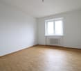 empty room, white walls, wooden floor, single window, white radiator