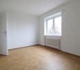 Wooden floor, white walls, window, radiator