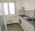 modern kitchen, gas stove, oven, sink, cabinets, window, radiator