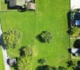 three houses, swimming pool, large green grass field