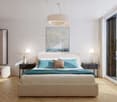 a spacious bedroom with a large bed, bedside tables, a chic lamp, and a built-in wardrobe