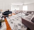 living room with a piano, couch, coffee table, rug, and chandelier