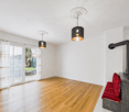 Empty room with wooden floor, white walls, sliding glass door, two lamps, fireplace