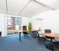 empty office with wooden desk, glass wall, carpeted floor