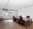 empty room, wooden floor, white walls, office table, 6 office chairs, glass windows, bright light