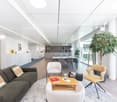 white walls, wooden floor, modern furniture, glass walls, plants, open dining space, modern decor