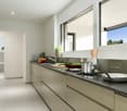 modern kitchen, countertop, white tiles, white cabinets, stainless steel sink, gas stove, dishwasher, windows, plants
