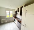 modern kitchen with white tiles, wooden countertops, white cabinets, stainless steel sink, dishwasher, electric oven, and a window with a view