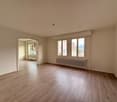empty room, hardwood floor, large windows, white walls, radiator