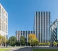 modern office building, large glass windows, located in urban setting, surrounding area has trees and street lights