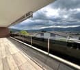 glass railing, wooden floor, panoramic view of mountains, sky