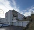 Modern building, white color, 3 floors, garage, parking place, car parked