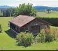 wooden house, surrounded by greenery, view