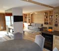 wooden wall, wooden floor, fireplace, couch, tv, dining table, chairs