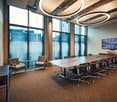 modern office room with large windows, conference table, and chairs