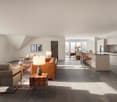 large open space, beige couches, leather couch, wooden coffee table, kitchen island, window, balcony, view of outside