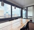dining room, wooden table, chairs, large windows, city view