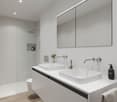 Modern bathroom, double vanity, separate shower, modern fixtures, white walls, tiled floor, white cabinets