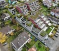Residential property with multiple buildings, solar panels on roofs, rooftop gardens, balcony, and parking.
