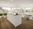 modern kitchen with dining area, island with sink, breakfast table, chairs, white walls, wooden floors, large windows leading to balcony, living room with white couch, coffee table, rug, and lamp