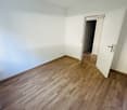 empty room, white walls, wooden floors, 2 doors