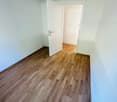 large open room, white walls, wooden floor, large entrance, closet