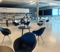 Meeting room, modern design, circular tables, round chairs, shelves with various items
