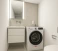 Laundry room with white floor, white washing machine, white toilet, and white sink