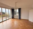 large windows, balcony, chandelier, wooden floor