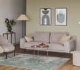 modern gray sofa, table with fruit bowl, chair, floor lamp, wall art, rug, side table with flowers