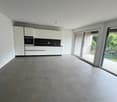 Empty kitchen, white cabinets, black countertop, glass doors to balcony, tiled floor