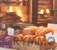 Croissants, bread, pastries, and other baked goods on display in a bakery