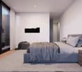 large bed, grey bedding, bedside tables, grey carpet, bedside lamp, sliding doors, balcony