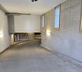 concrete walls, grey floor, white ceiling, small windows, lighting