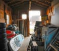 wooden walls, bicycle, storage boxes, inflatable floater, storage room