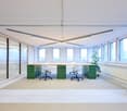 empty office with tables, large windows, brown curtains
