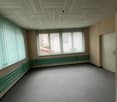 empty room, carpeted floor, windows with horizontal blinds, radiators