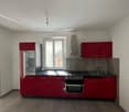 modern kitchen with red cabinets, stainless steel appliances, tiled floor, window with view