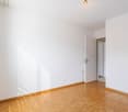 empty room, wooden floor, white walls, open door, light coming from outside