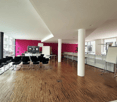 Empty room with wooden floor, pink walls, white ceiling, chairs, TV, whiteboard