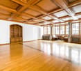large room, wooden floor, wooden ceiling, large windows, wooden cabinet, wooden desk, radiators