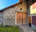 Stone house, wooden doors, wooden shutters, stone bench, mossy grass, wooden bench